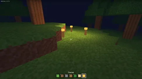 Eine Blockwelt mit Bäumen auf grüner Wiese, unten eine Leiste mit Blöcken zum Bauen
